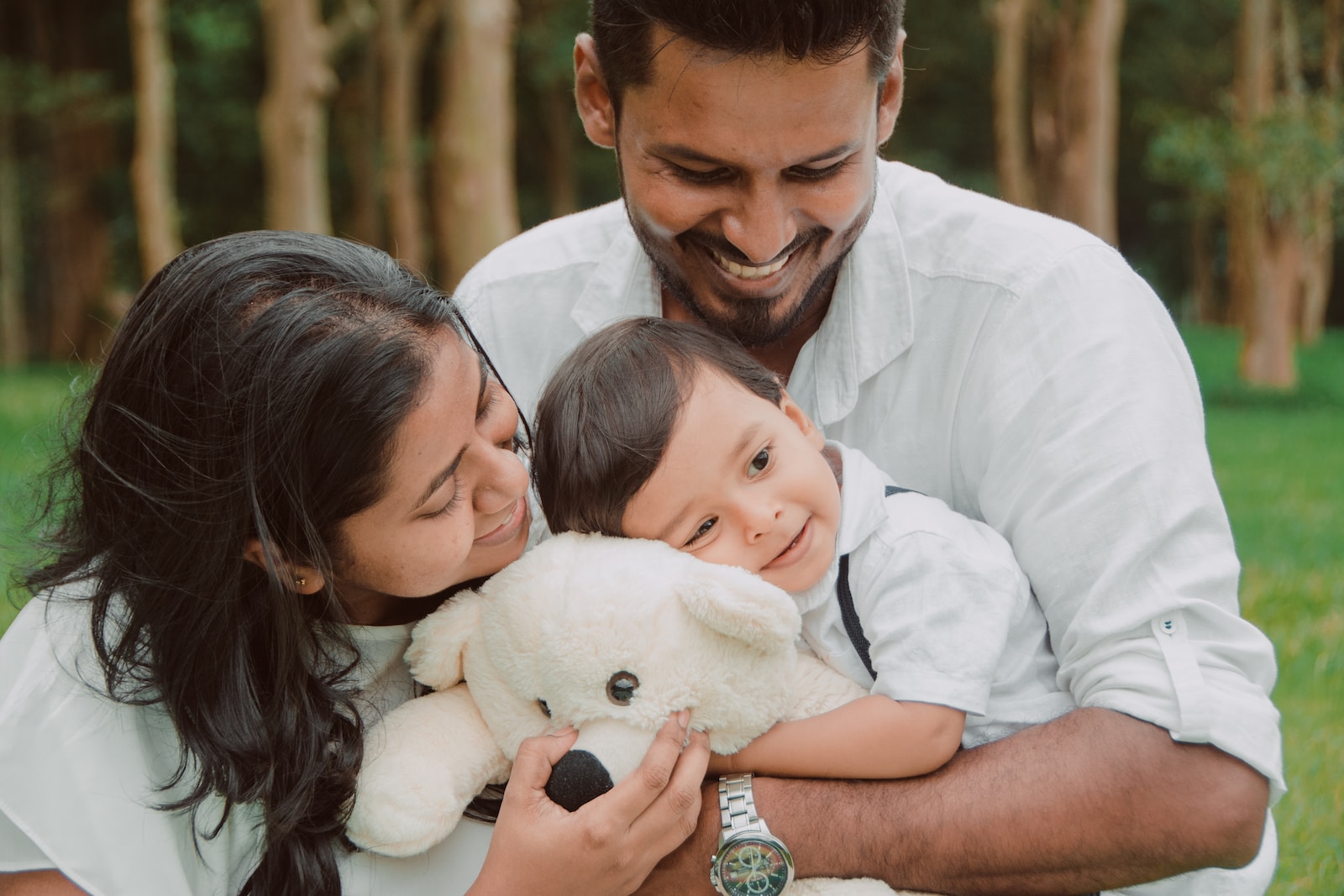 a man and woman holding a baby